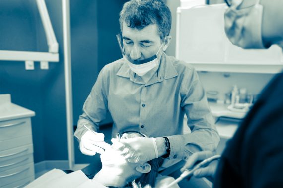 Dr.Vasilian doing dental exam on patient